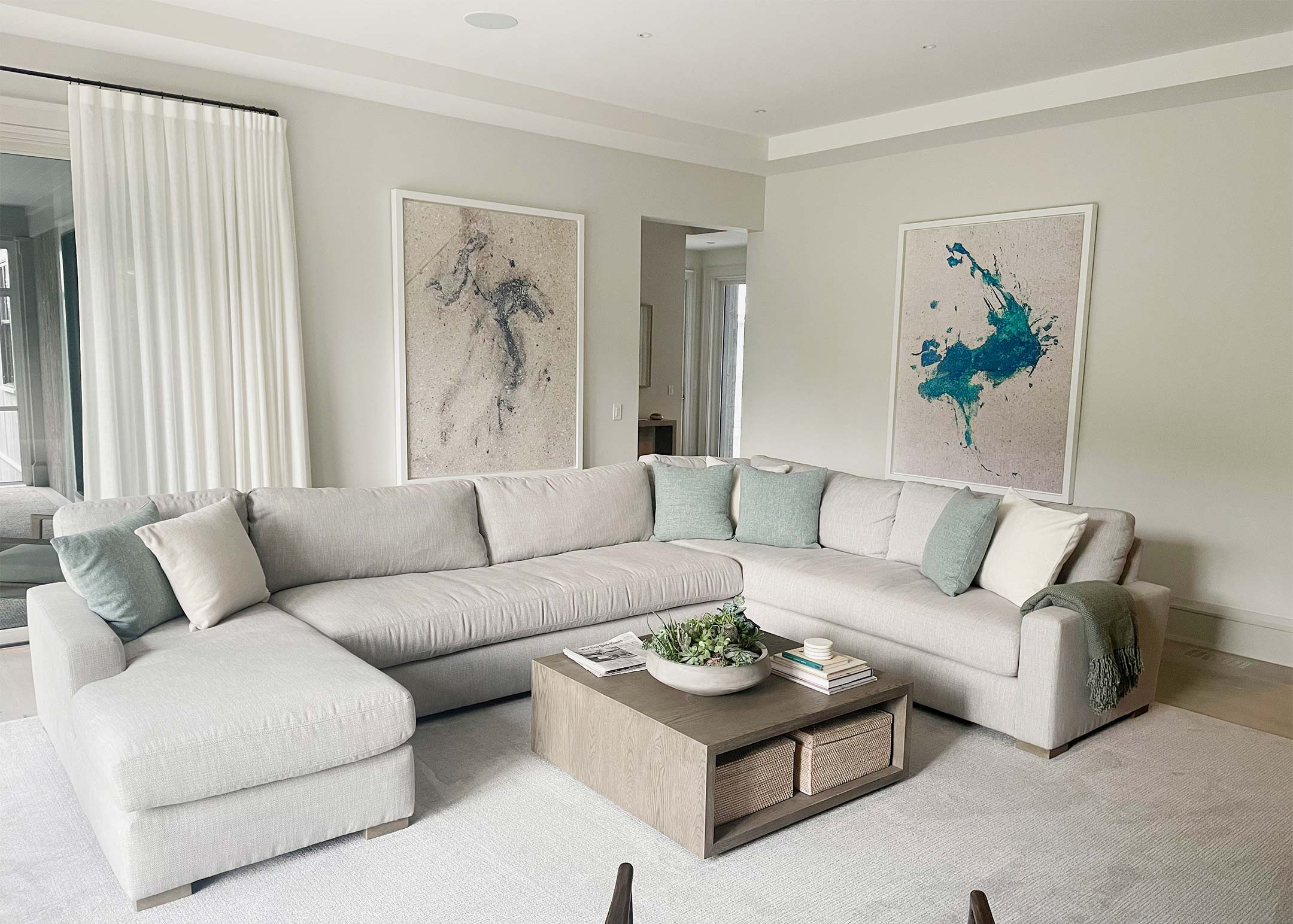 A picture of two framed fine art photographs of New York City hanging on the walls of a beautiful living room.