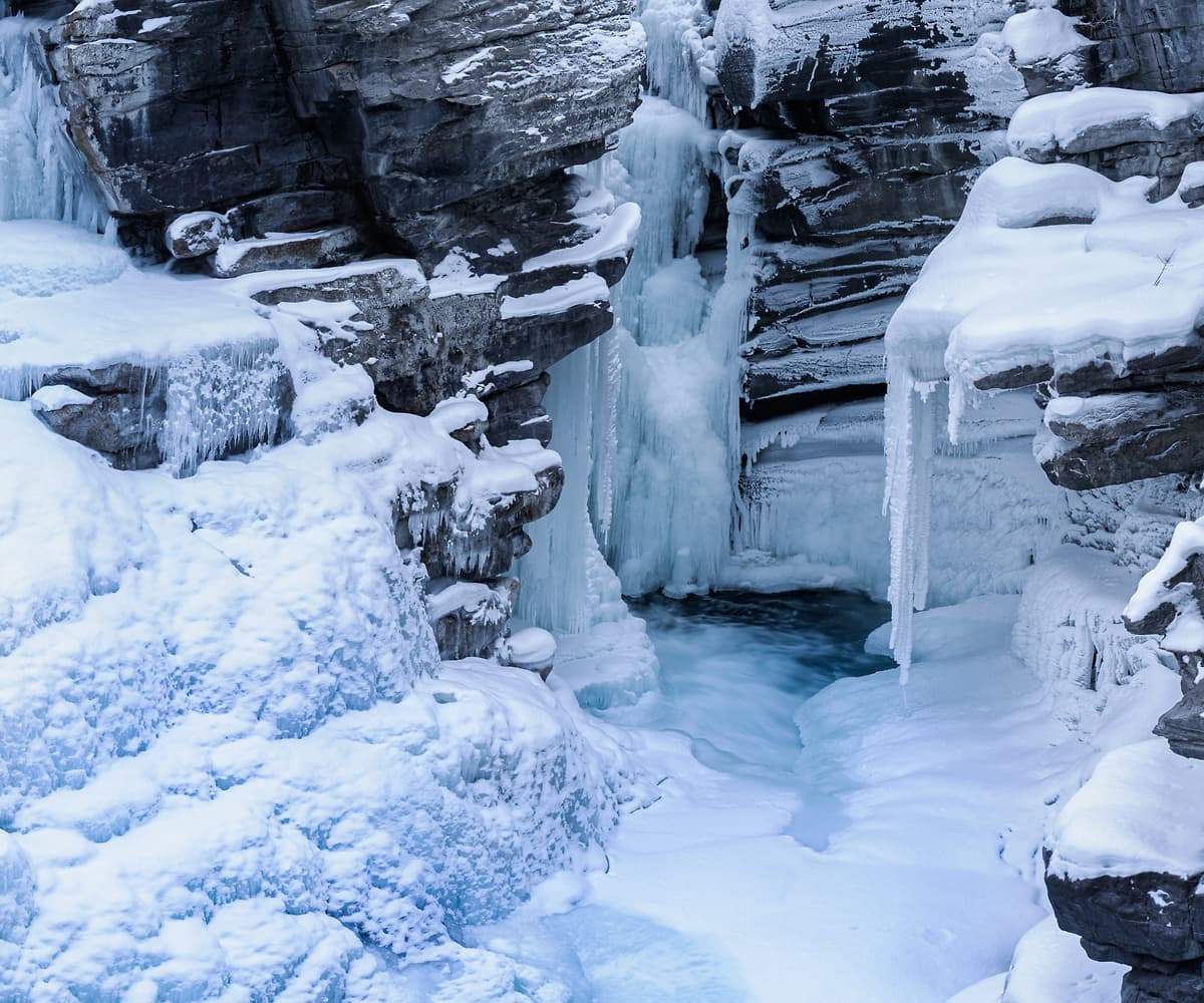 683 megapixels! A very high resolution, large-format VAST photo print of Jasper National Park in winter with Athabasca Falls frozen, snow covering the ground, and mountains in the background; wintertime landscape photograph created by Scott Dimond at Athabasca Falls in Jasper National Park, Alberta, Canada.