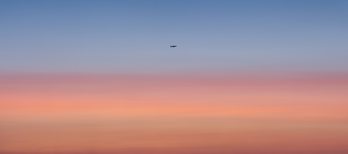 452 megapixels! A very high resolution, large-format VAST photo of an airplane taking off or landing in a vibrant, pastel, colorful sunset; fine art airplane photograph created by Dan Piech in New York City.