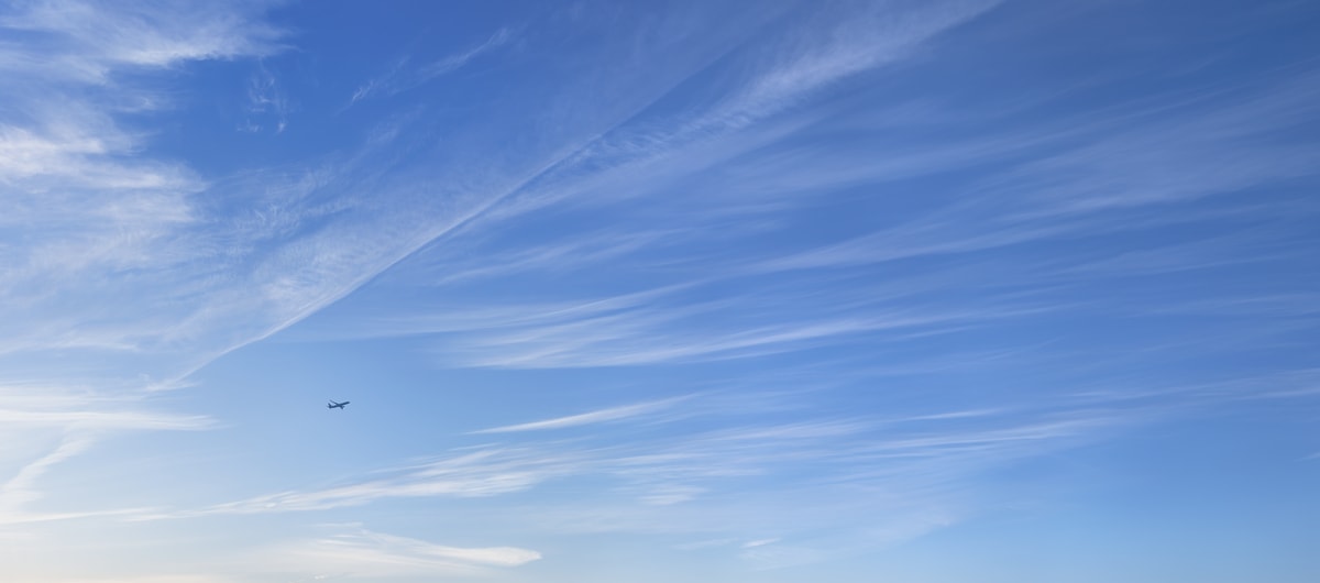 591 megapixels! A very high resolution, large-format VAST photo print of an airplane taking off in front of a beautiful blue sky day with wispy clouds; air travel photograph created by Dan Piech in New York City.