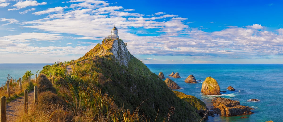 1,743 megapixels! A very high resolution, large photo art print of a beautiful lighthouse on a rocky point in front of the ocean; seascape photograph created by John Freeman in Nugget Point, New Zealand.