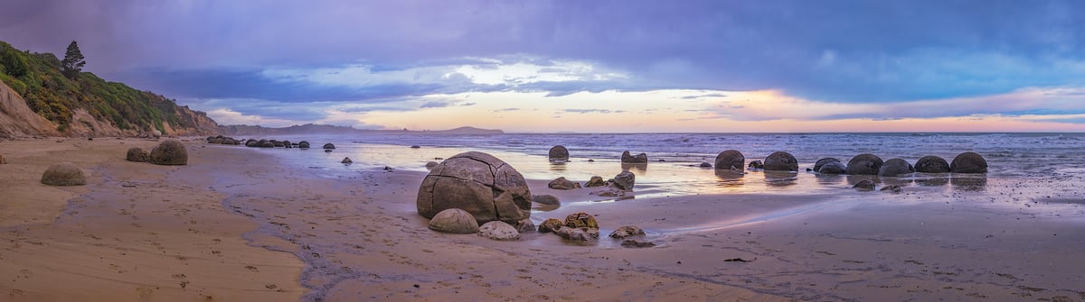 615 megapixels! A very high resolution, large-format panorama photo print of a rocky beach with beautiful, round boulders at sunset; seascape photograph created by John Freeman in Moeraki, New Zealand.