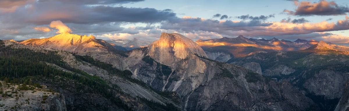 279 megapixels! A very high resolution, panorama photo print of the Yosemite landscape at sunset with Half Dome, Clouds Rest, and other ridgelines and peaks illuminated by the setting sun; panorama photograph created by Jeff Lewis in Yosemite National Park, California.
